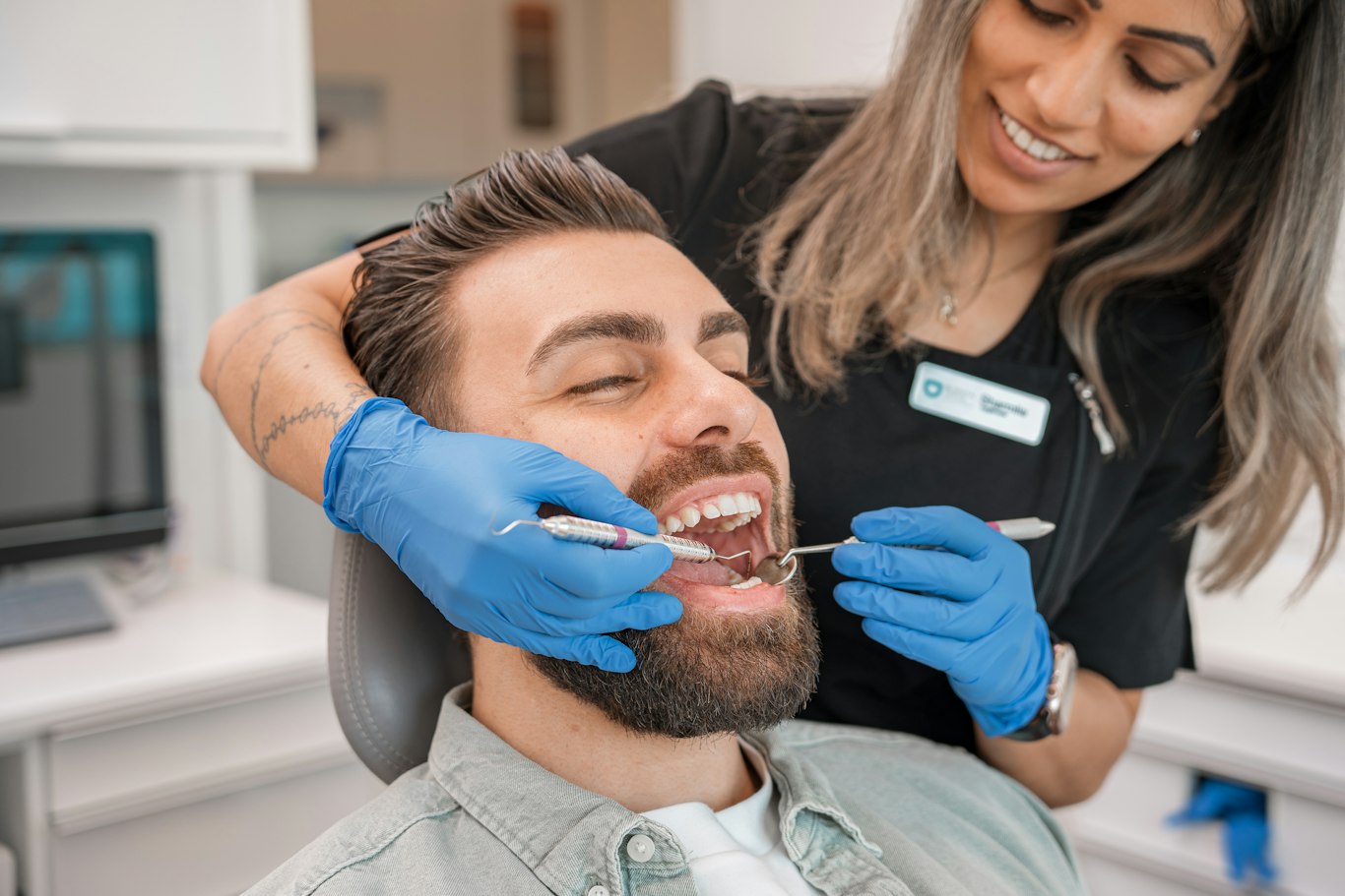 Relaxed patient smiling in the dental chair after overcoming dental anxiety