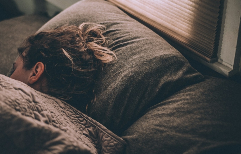 Woman sleeping, as teeth grinding often happens at night