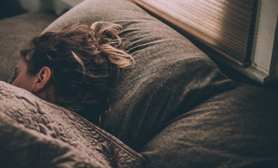 Woman sleeping, as teeth grinding often happens at night