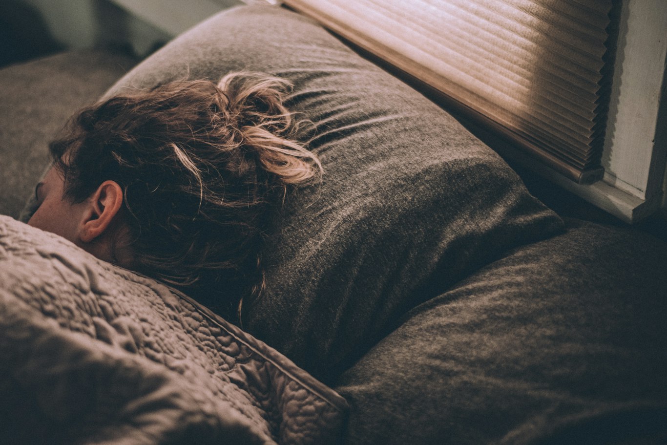 Woman sleeping, as teeth grinding often happens at night