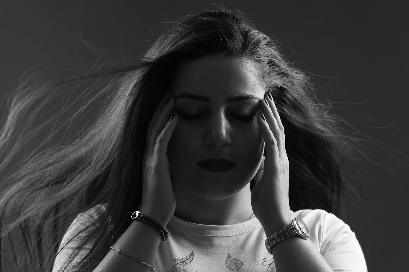 Woman with headache and jaw tension caused by teeth grinding