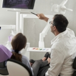 Dentist explaining dental insurance benefits to a patient in Muncie, IN