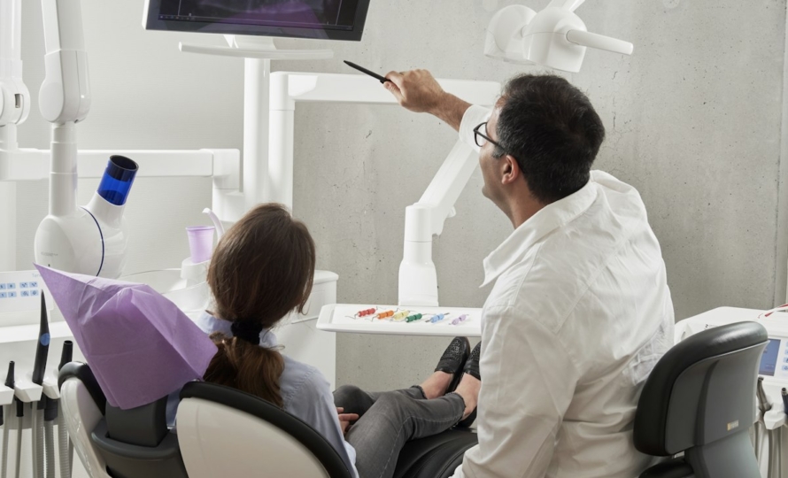 Dentist explaining dental insurance benefits to a patient in Muncie, IN