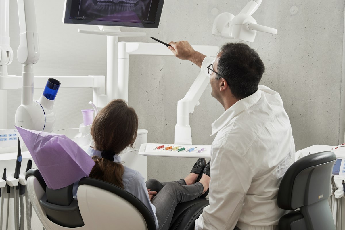 Dentist explaining dental insurance benefits to a patient in Muncie, IN